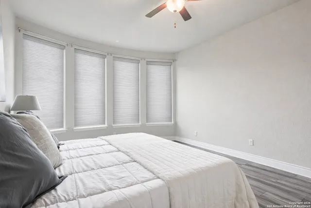 a living room with furniture and a ceiling fan