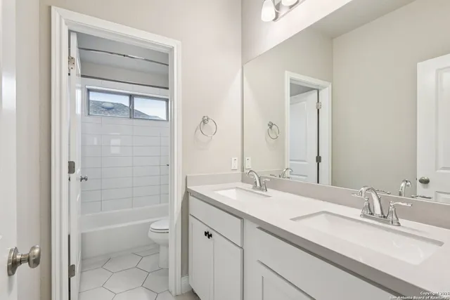 a picture of a bathroom with a shower