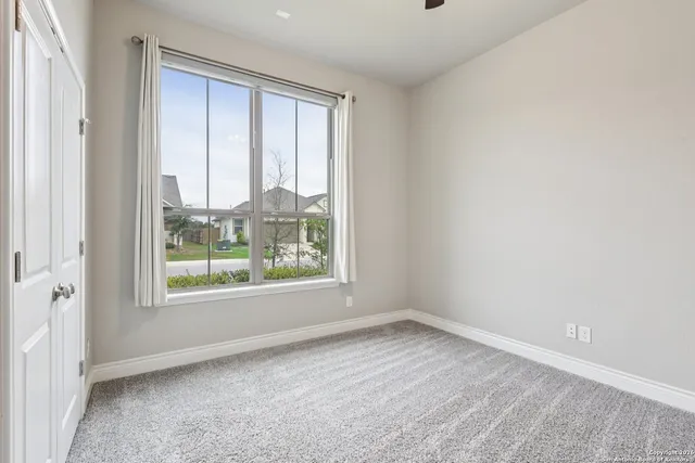 a view of a workspace with a table and chair