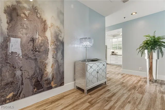 a very nice looking room with a wooden floor and a potted plant