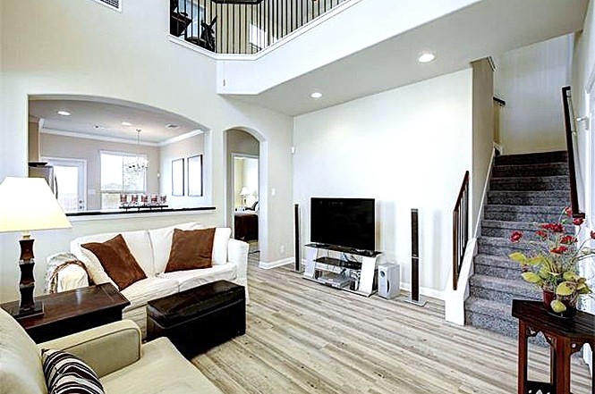 14001 Avery Ranch Boulevard, Unit 801 Austin, TX 78717 - Photo 26 of 26 A grand, naturally illuminated living area showcases high ceilings and an open floorplan, flowing into the kitchen.