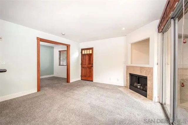 a living room with a fireplace and a rug