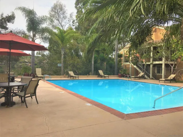 a view of house with swimming pool outdoor seating