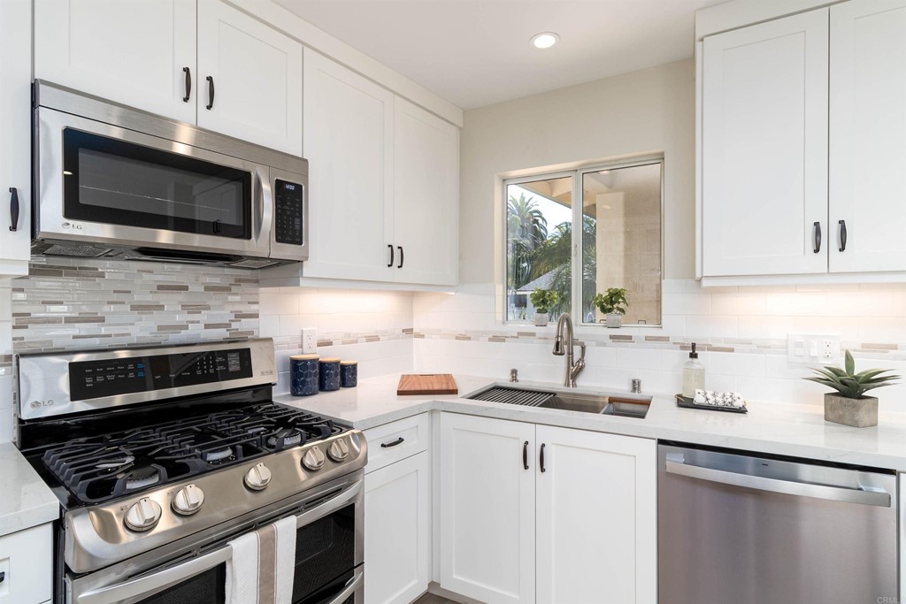 3915 Linmar Lane Carlsbad, CA 92008 - Photo 12 of 25 a kitchen with stainless steel appliances a stove a microwave a sink and cabinets
