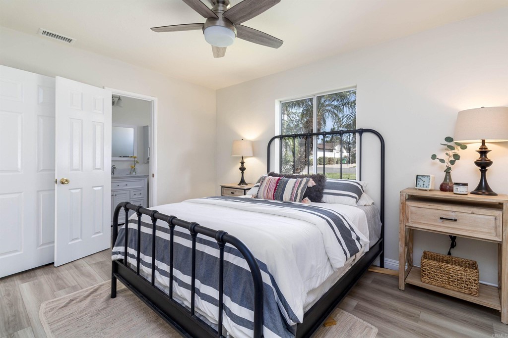 3915 Linmar Lane Carlsbad, CA 92008 - Photo 6 of 25 a bedroom with a bed and a chandelier