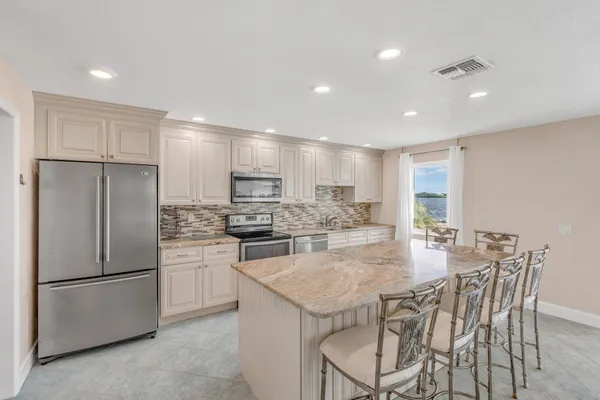 a living room with furniture and kitchen view
