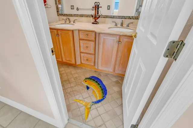 a spacious bedroom with a bed and a chandelier