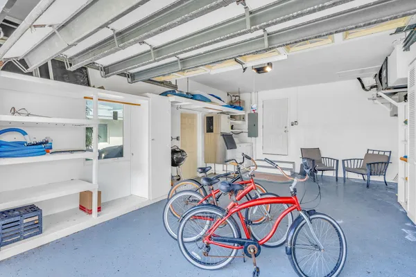 a bedroom with a bed a dresser and a large window
