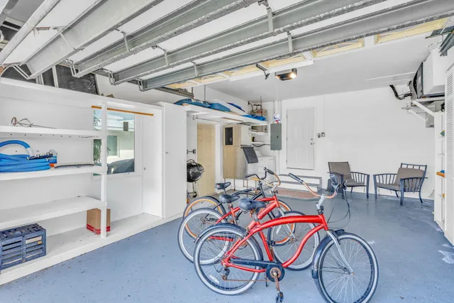 a bedroom with a bed a dresser and a large window
