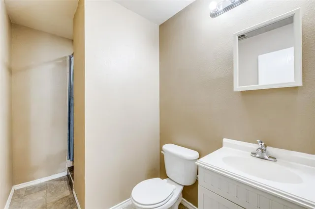 a white toilet sitting next to a bathroom sink