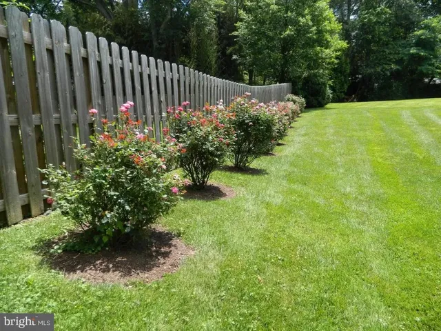 a view of a dining room with furniture a chandelier and wooden floor