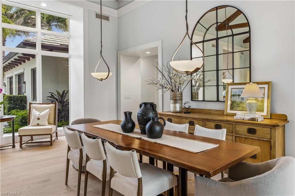 600 Anchor Rode Drive Naples, FL 34103 - Photo 5 of 29 Dining area featuring wood finished floors, a towering ceiling, and recessed lighting