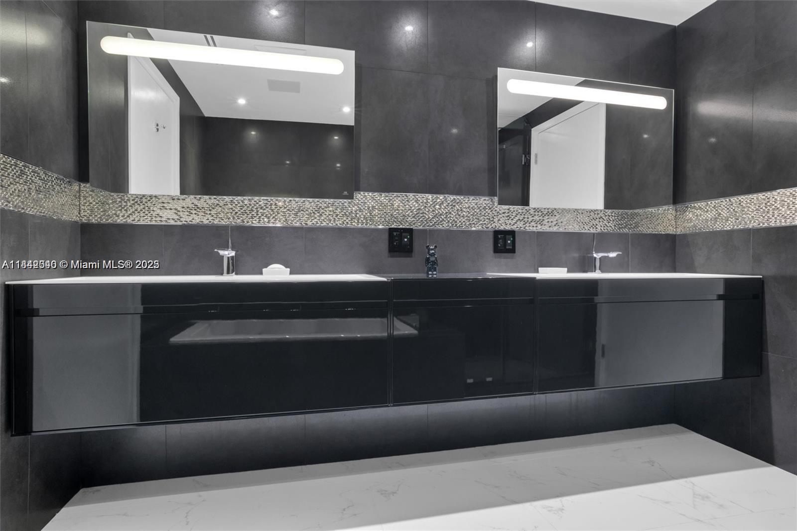 3801 Collins Avenue, Unit 1104 Miami Beach, FL 33140 - Photo 19 of 43 a bathroom with a double vanity sink and a mirror