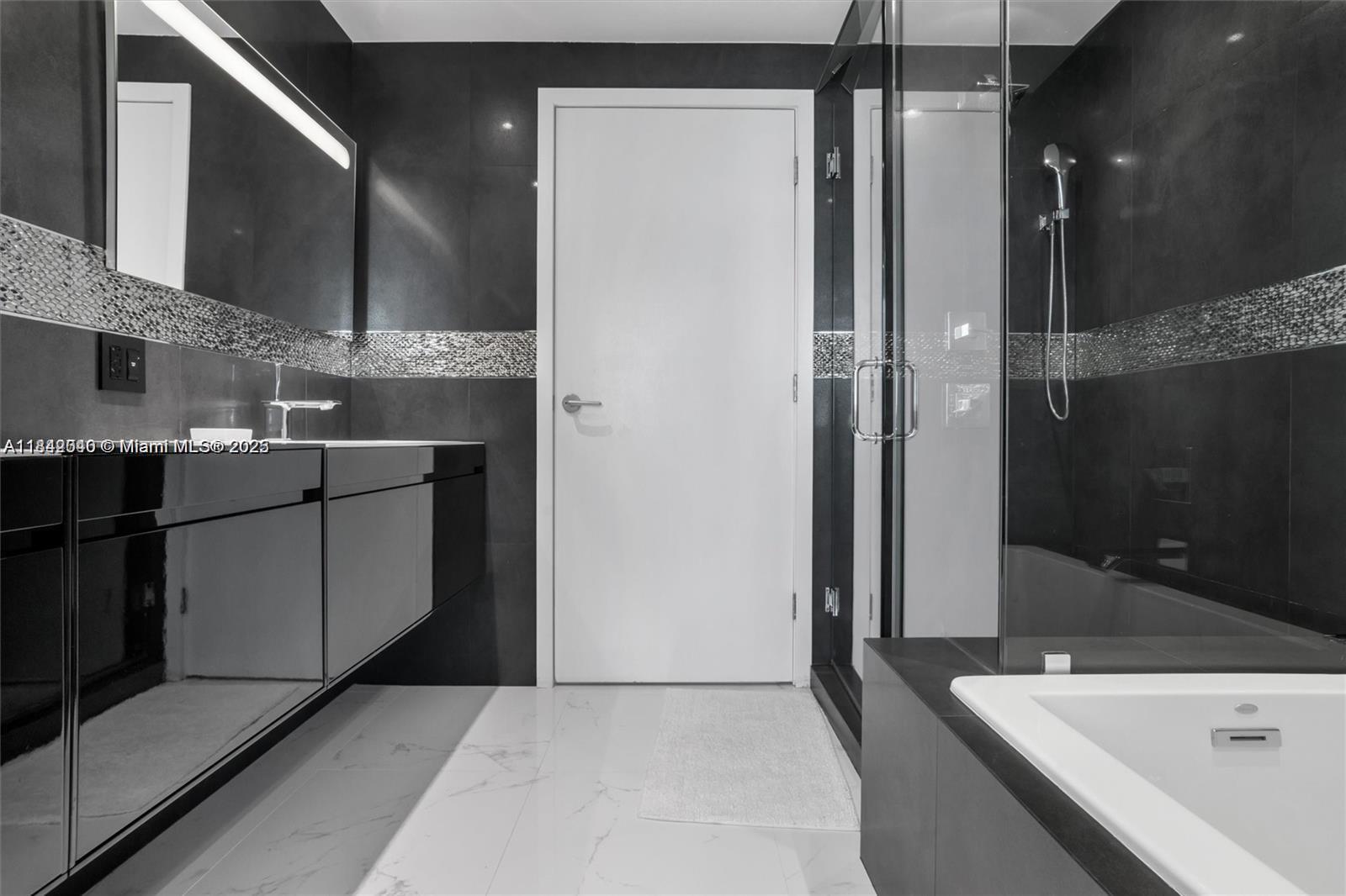 3801 Collins Avenue, Unit 1104 Miami Beach, FL 33140 - Photo 20 of 43 a kitchen with a sink and refrigerator