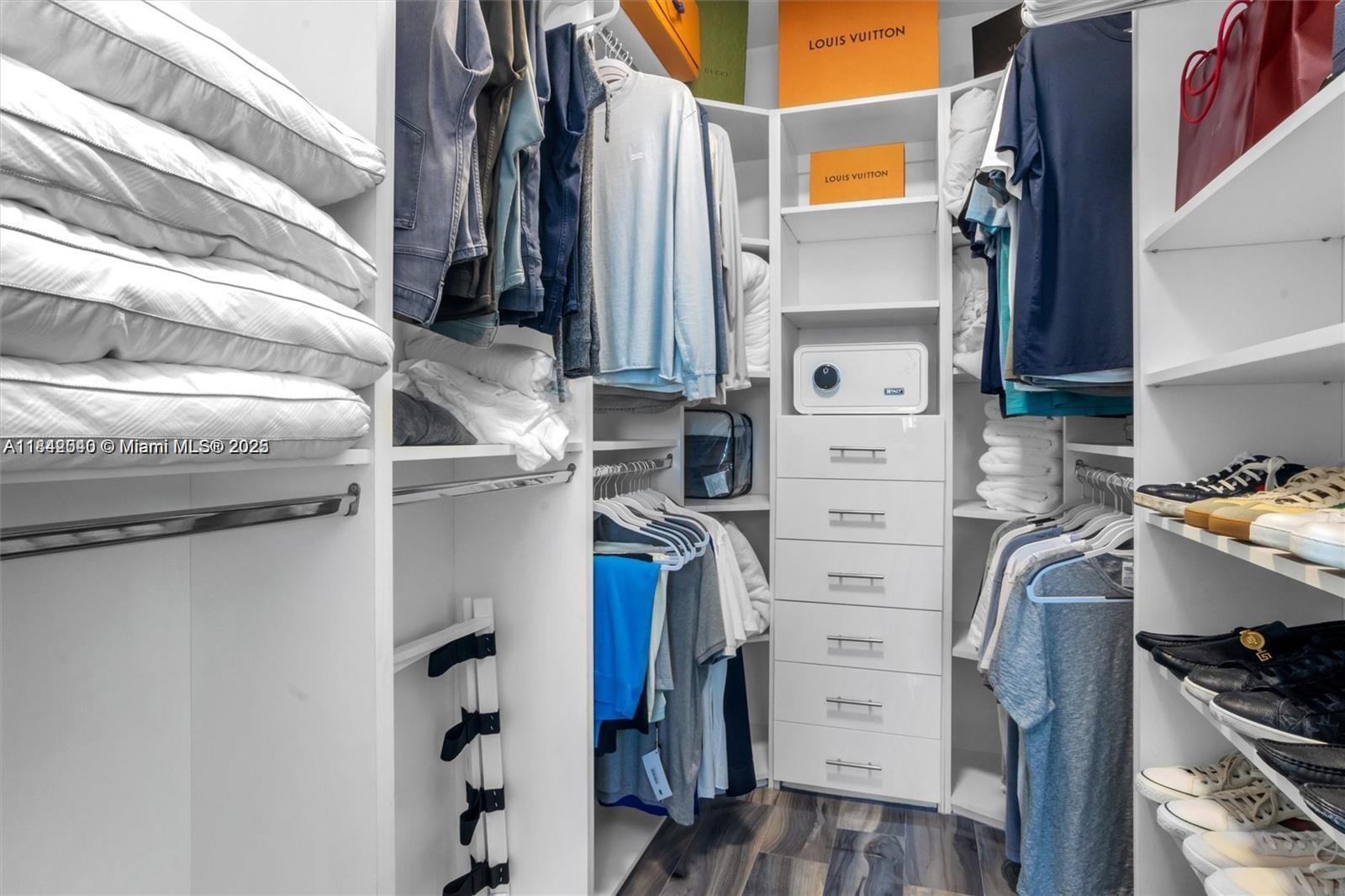 3801 Collins Avenue, Unit 1104 Miami Beach, FL 33140 - Photo 21 of 43 a view of walk in closet with clothes and shoes