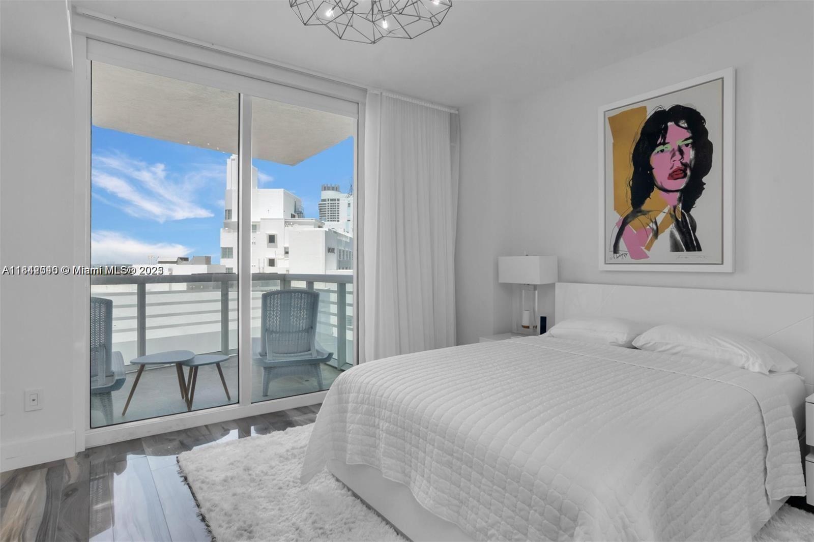 3801 Collins Avenue, Unit 1104 Miami Beach, FL 33140 - Photo 22 of 43 a bedroom with a bed and a painting on the wall