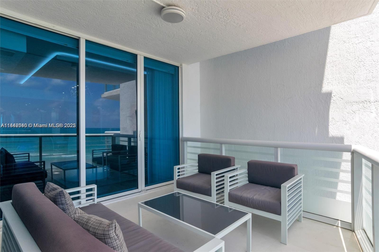 3801 Collins Avenue, Unit 1104 Miami Beach, FL 33140 - Photo 27 of 43 a outdoor living space with a couch and a potted plant