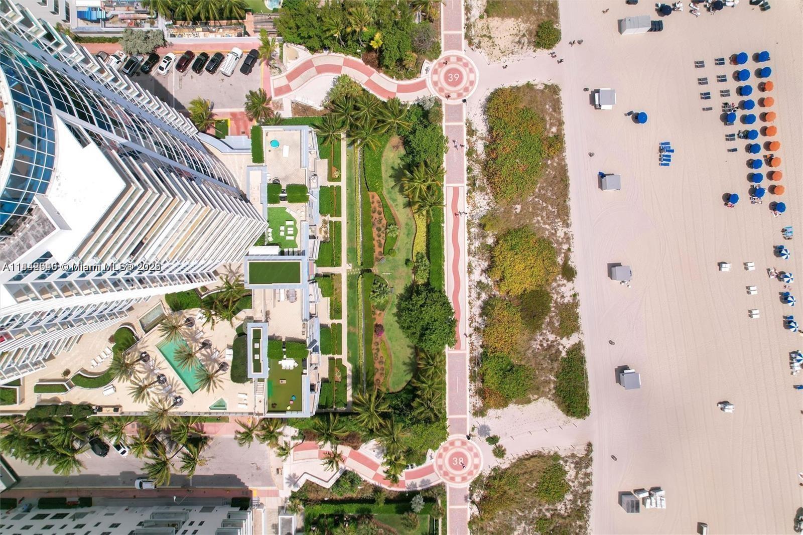 3801 Collins Avenue, Unit 1104 Miami Beach, FL 33140 - Photo 28 of 43 an aerial view of a residential apartment building with a yard and potted plants