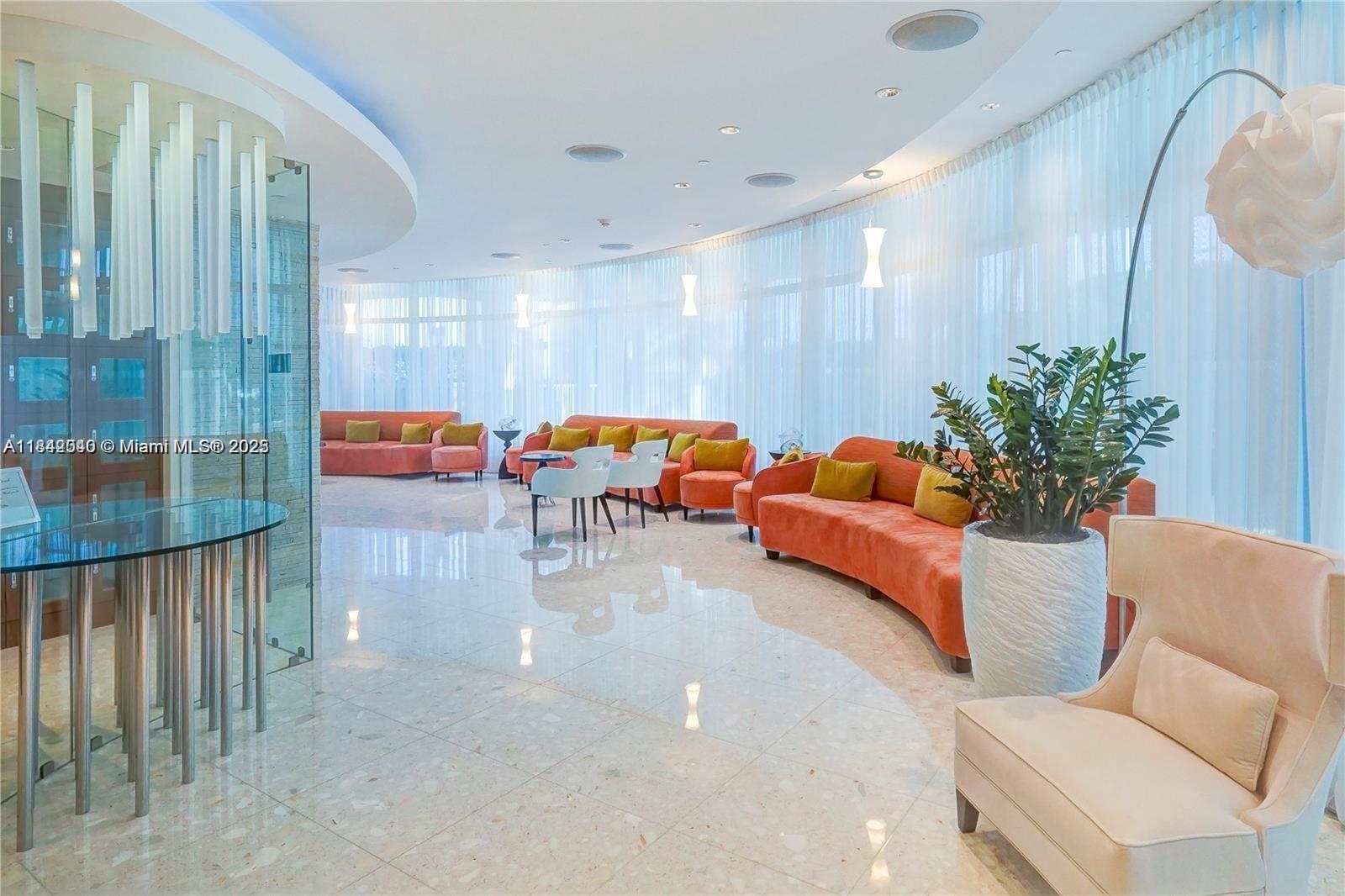 3801 Collins Avenue, Unit 1104 Miami Beach, FL 33140 - Photo 32 of 43 a reading room with furniture and wooden floor