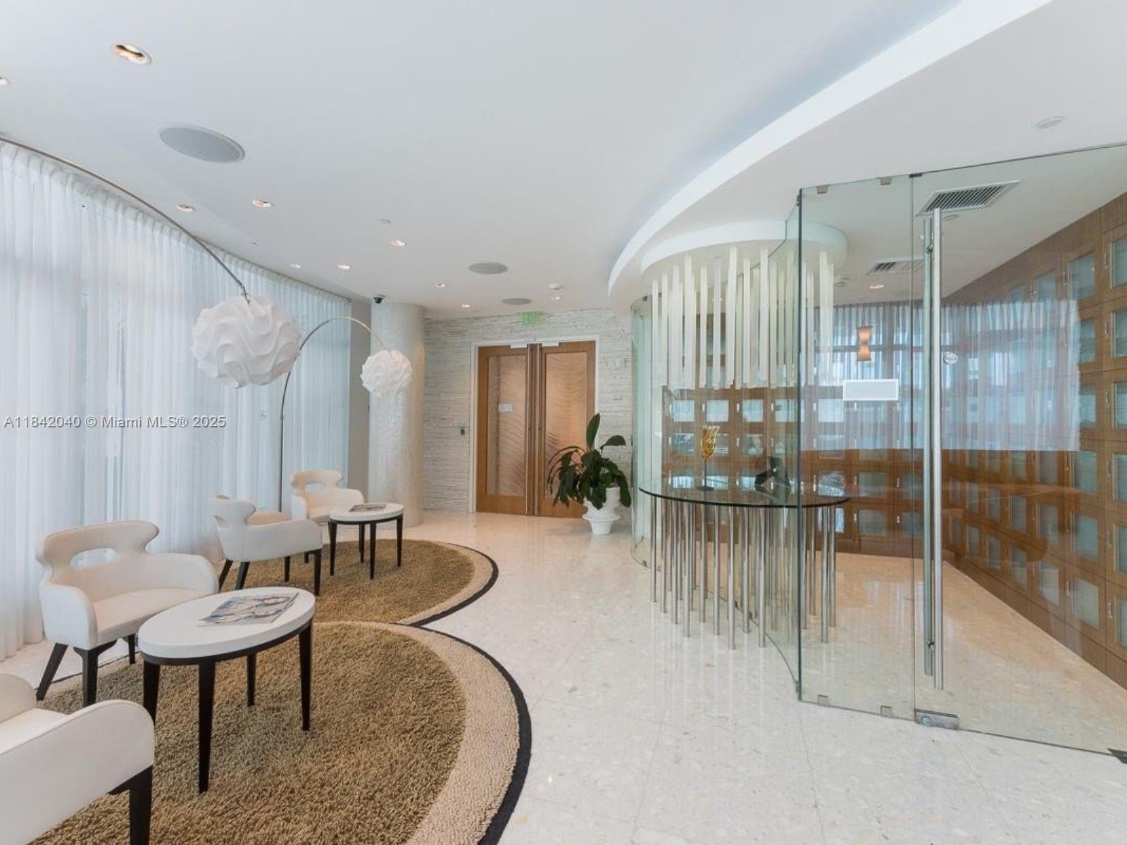 3801 Collins Avenue, Unit 1104 Miami Beach, FL 33140 - Photo 36 of 43 a living room with furniture and a table