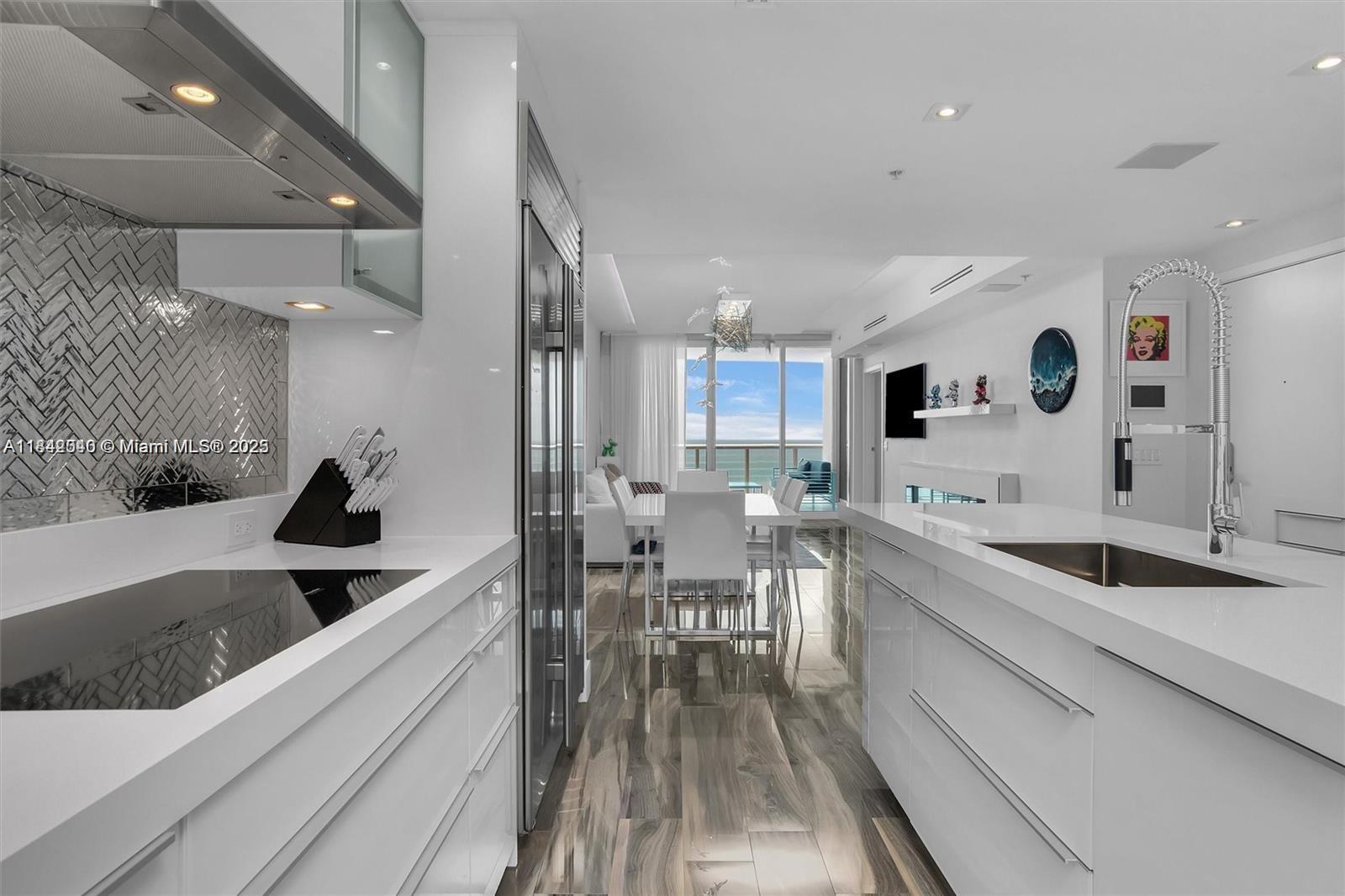 3801 Collins Avenue, Unit 1104 Miami Beach, FL 33140 - Photo 10 of 43 a kitchen with a sink and cabinets