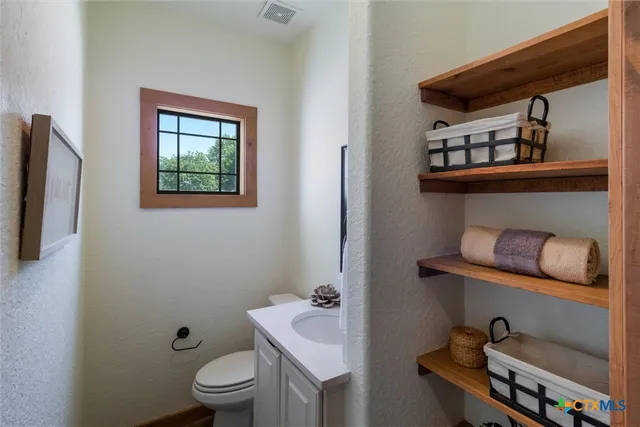 a bathroom with a toilet a sink and a mirror