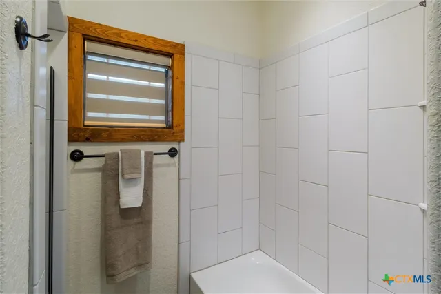 a bathroom with a toilet and shower