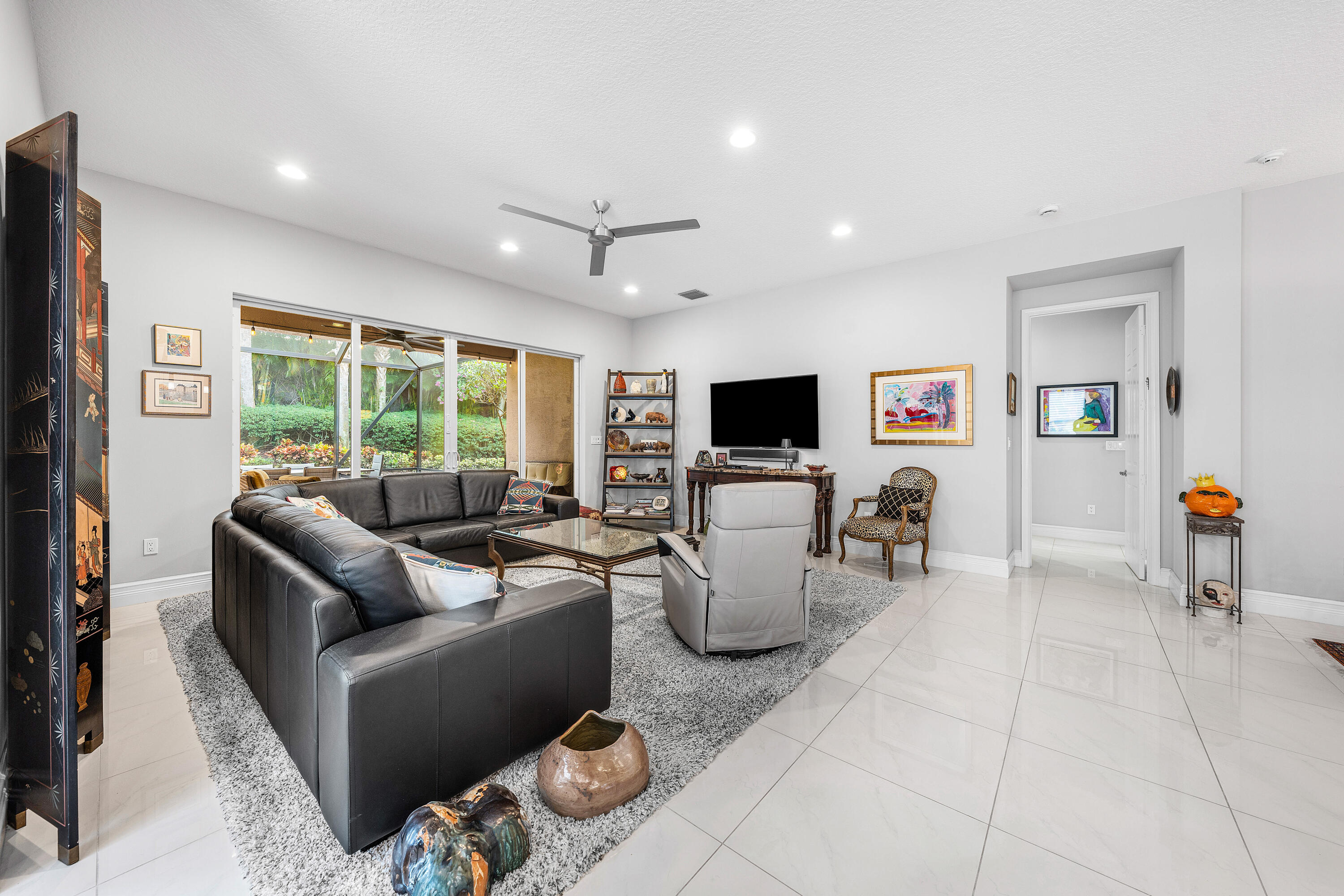 11639 Dawson Range Road Boynton Beach, FL 33473 - Photo 16 of 75 a living room with furniture a flat screen tv and a window