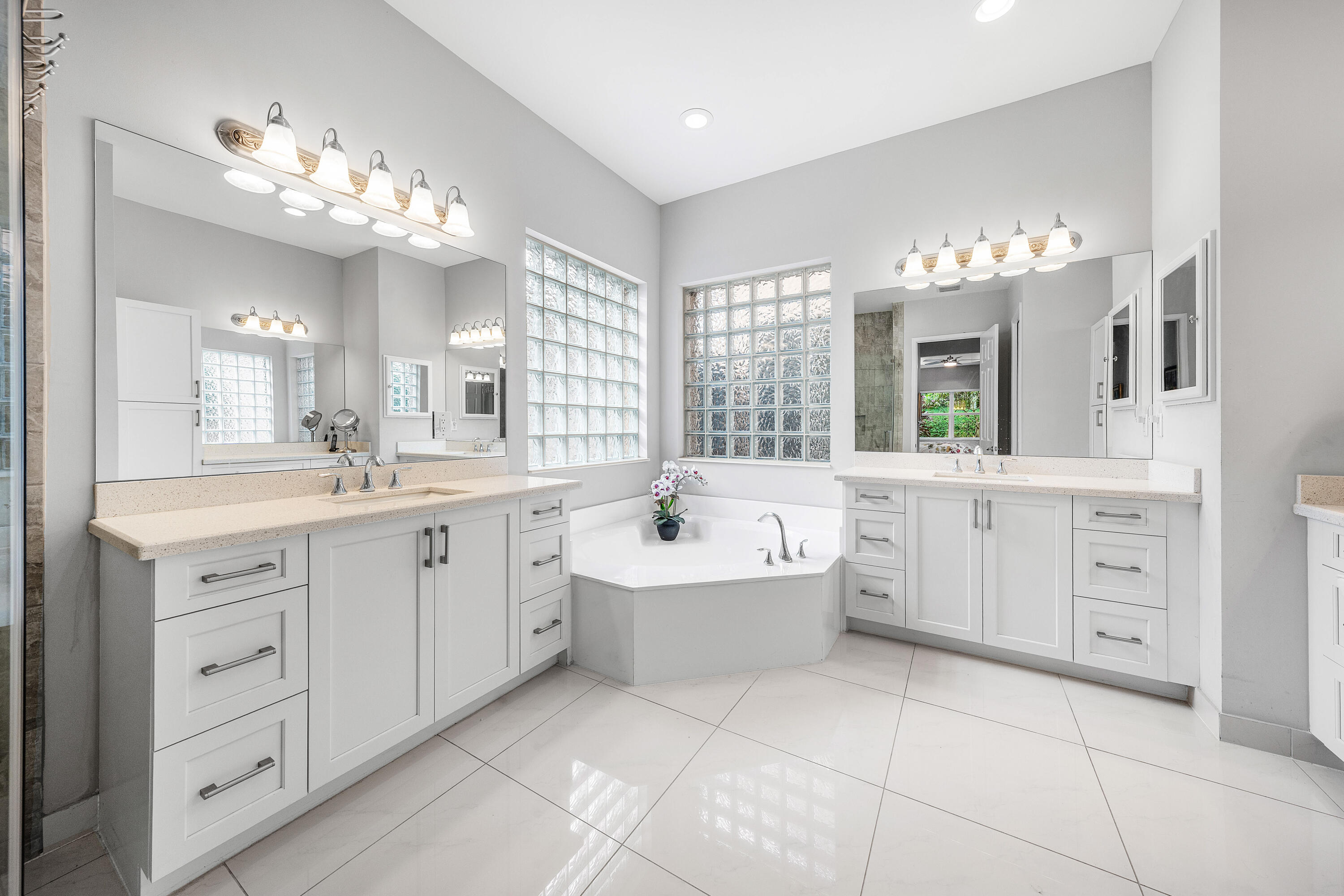 11639 Dawson Range Road Boynton Beach, FL 33473 - Photo 23 of 75 a spacious en suite bathroom with a double vanity sink a mirror a bathtub and a window