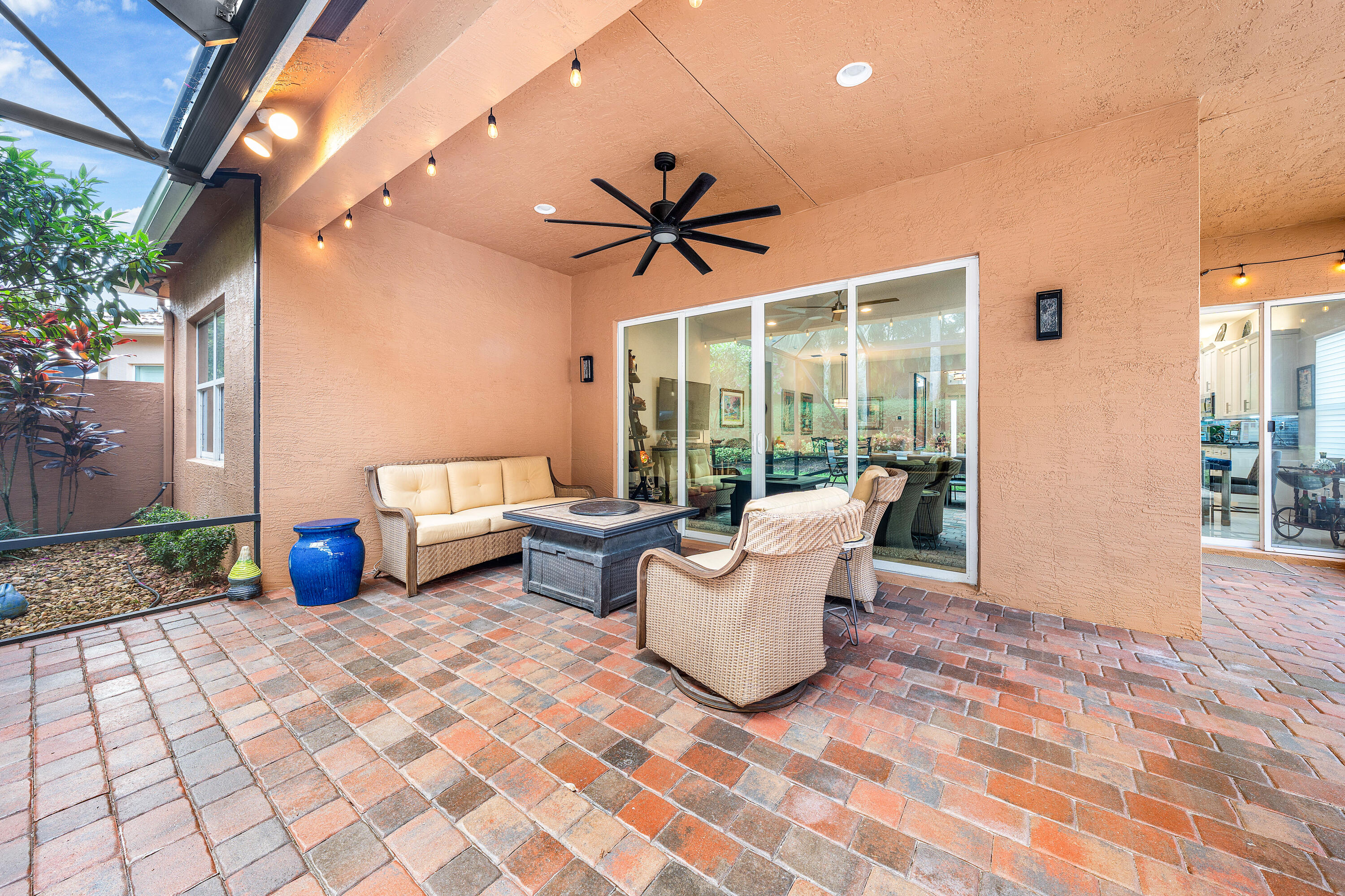 11639 Dawson Range Road Boynton Beach, FL 33473 - Photo 32 of 75 a living room with patio furniture and a floor to ceiling window