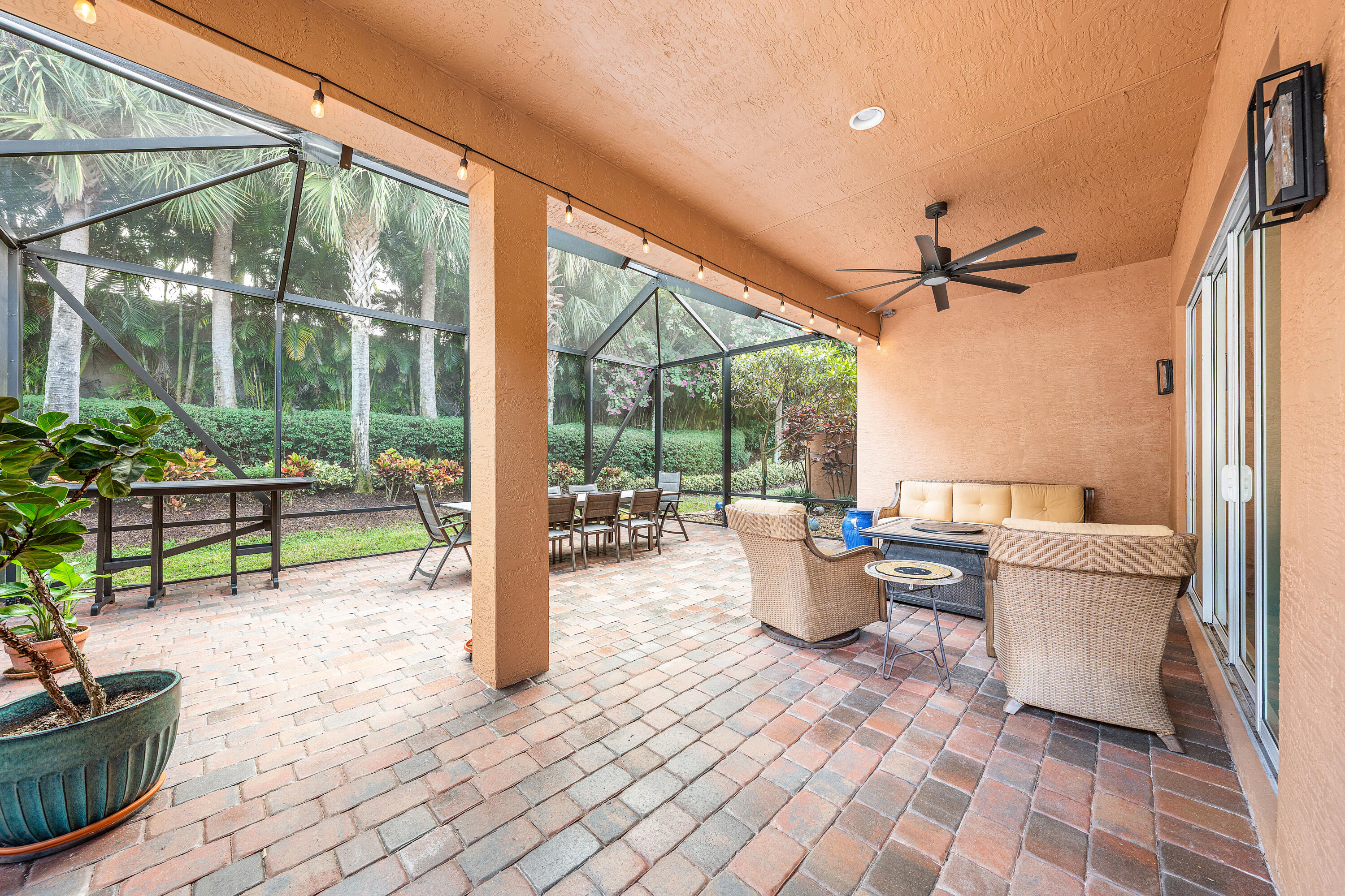 11639 Dawson Range Road Boynton Beach, FL 33473 - Photo 35 of 75 a living room with patio furniture and a floor to ceiling window