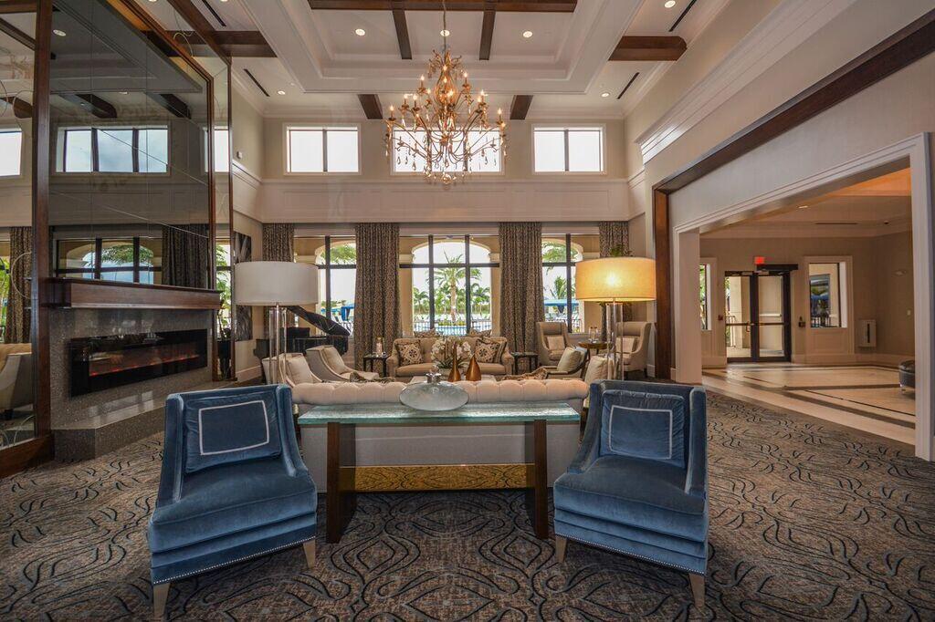 11639 Dawson Range Road Boynton Beach, FL 33473 - Photo 54 of 75 a living room with furniture a chandelier and a fireplace