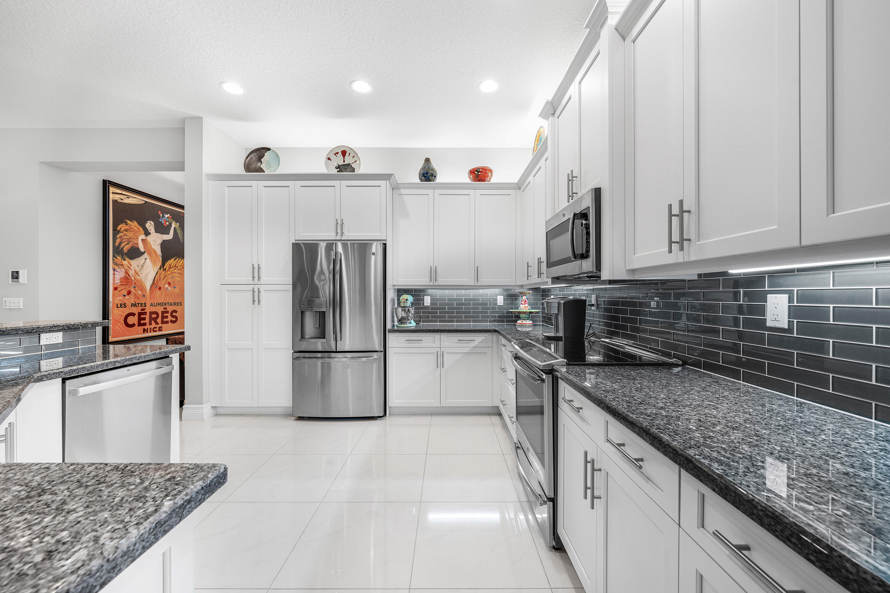 11639 Dawson Range Road Boynton Beach, FL 33473 - Photo 9 of 75 a kitchen with stainless steel appliances granite countertop a refrigerator and a sink