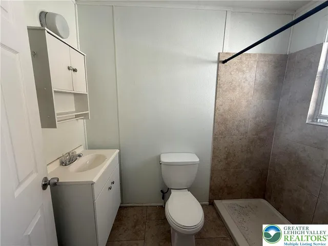 a white toilet sitting next to a bathroom sink