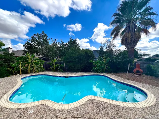 a view of swimming pool with seating space