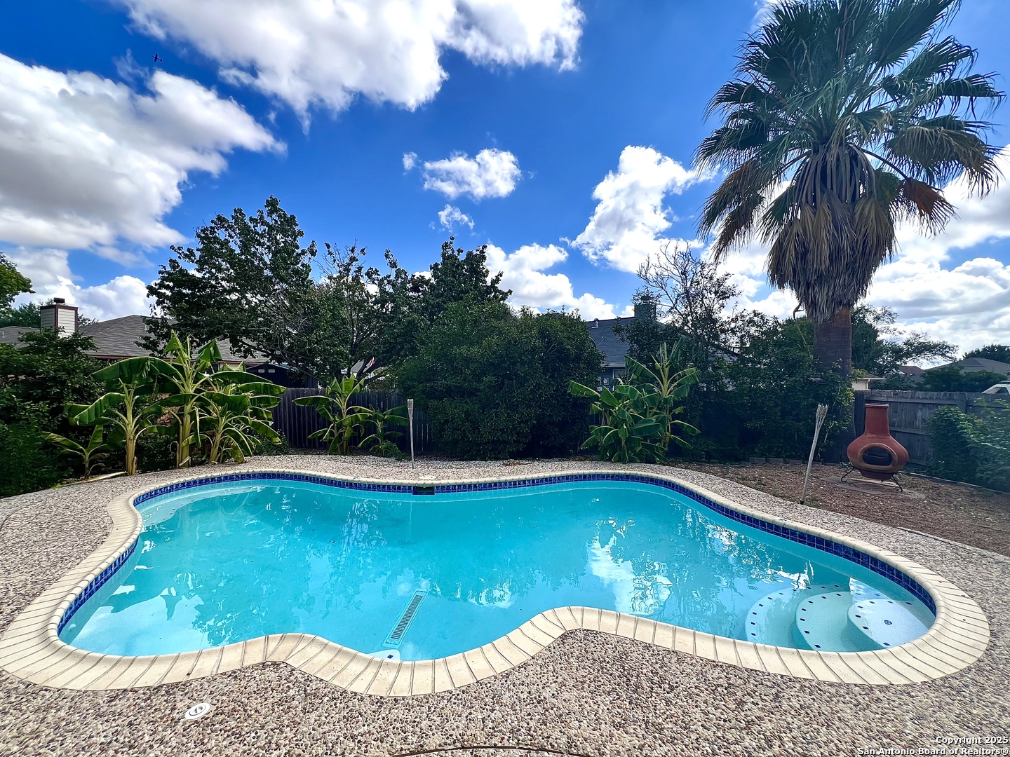 a view of swimming pool with seating space