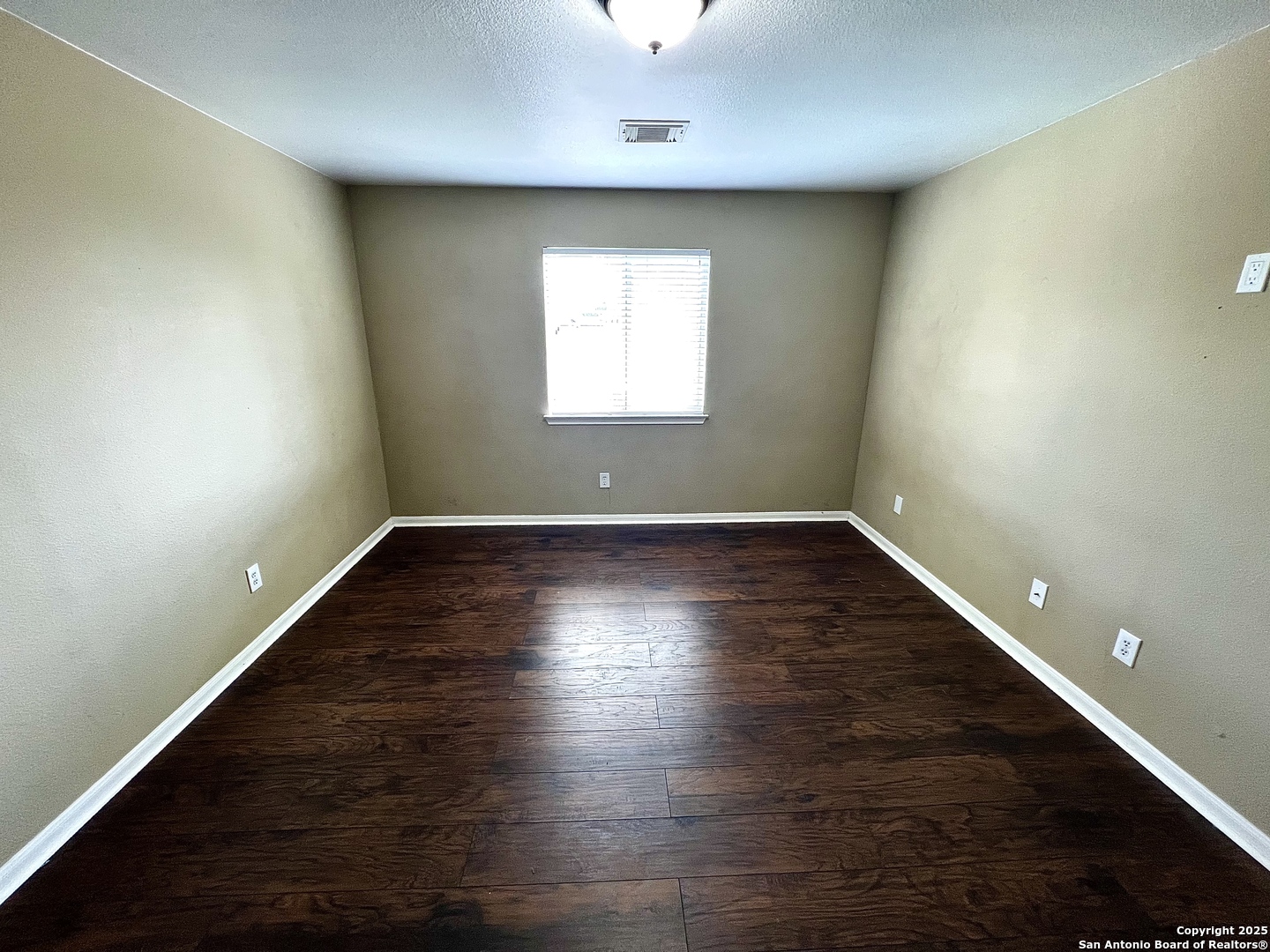 8218 Coppergate Converse, TX 78109 - Photo 12 of 15 an empty room with wooden floor and windows