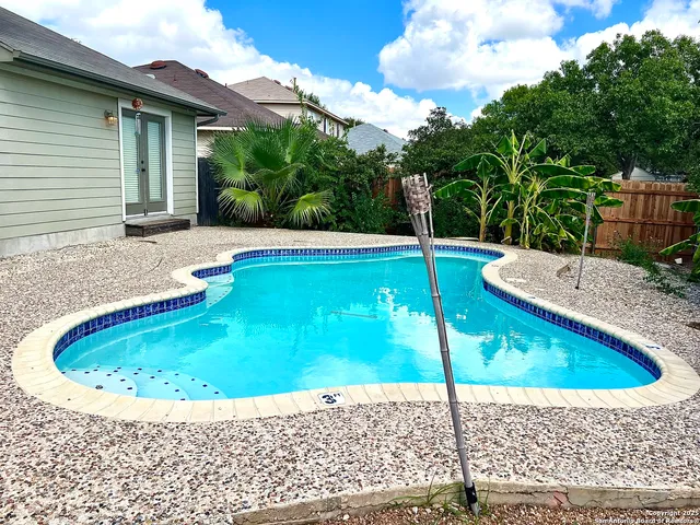 a view of a swimming pool with a patio