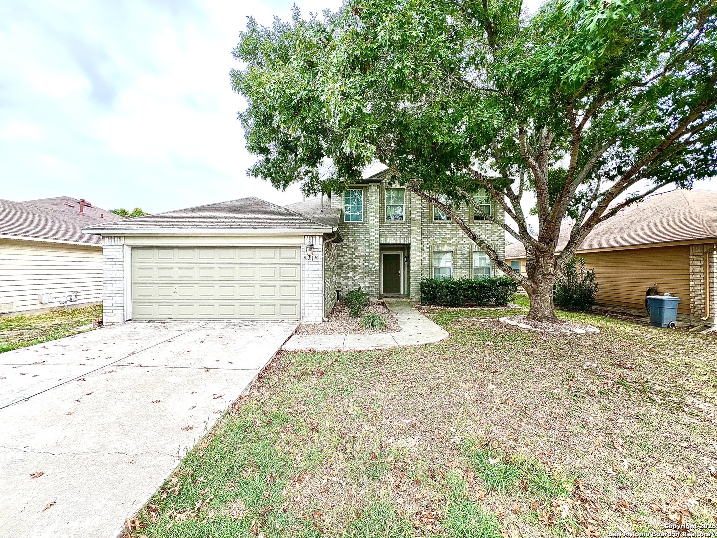 8218 Coppergate Converse, TX 78109 - Photo 2 of 15 a front view of a house with a yard and garage