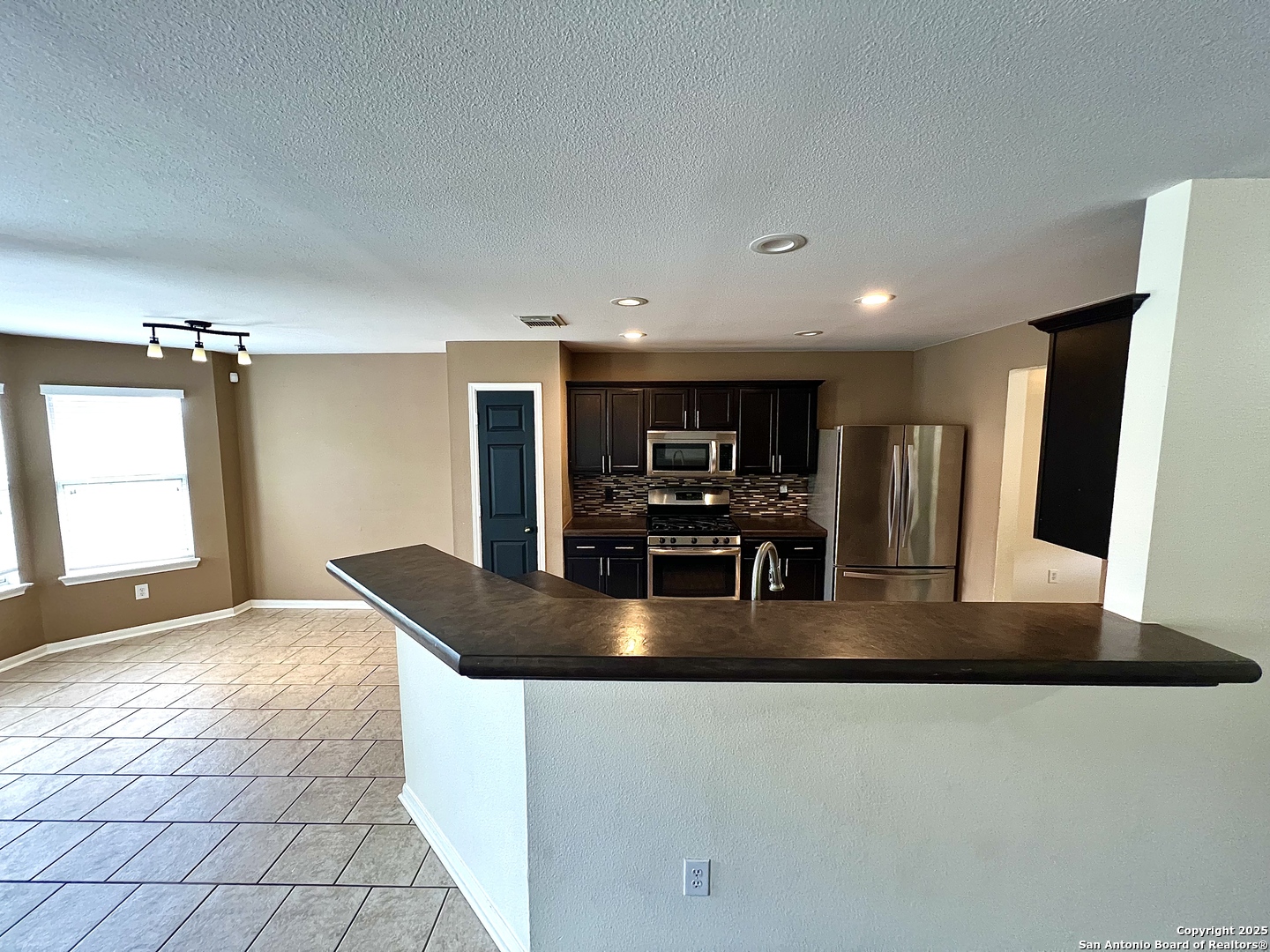 8218 Coppergate Converse, TX 78109 - Photo 4 of 15 a view of a kitchen with stainless steel appliances granite countertop a refrigerator a sink and a stove