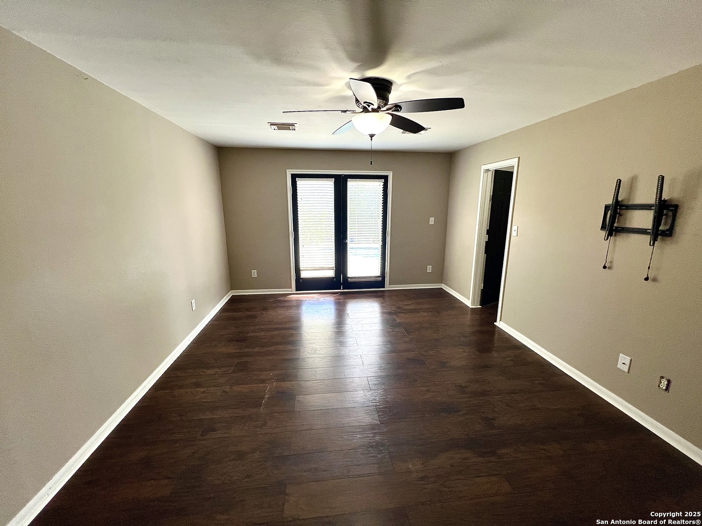 8218 Coppergate Converse, TX 78109 - Photo 8 of 15 a view of an empty room with wooden floor and a window