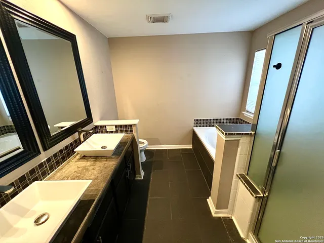 a bathroom with a tub sink and a mirror