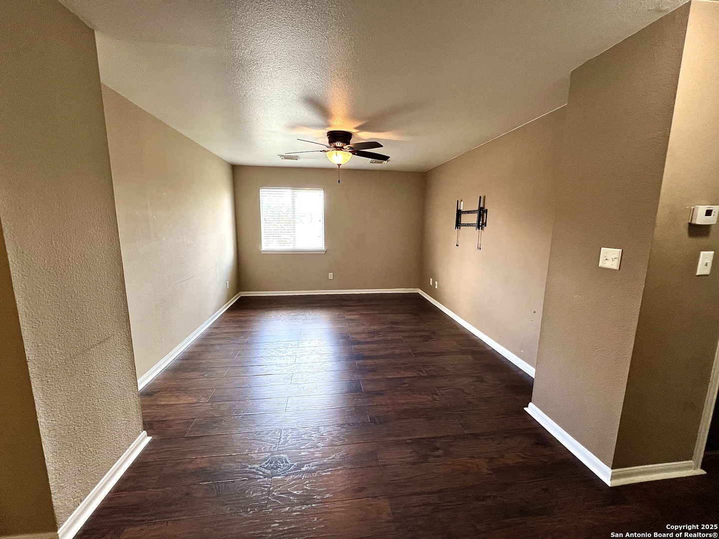 8218 Coppergate Converse, TX 78109 - Photo 10 of 15 an empty room with wooden floor and windows