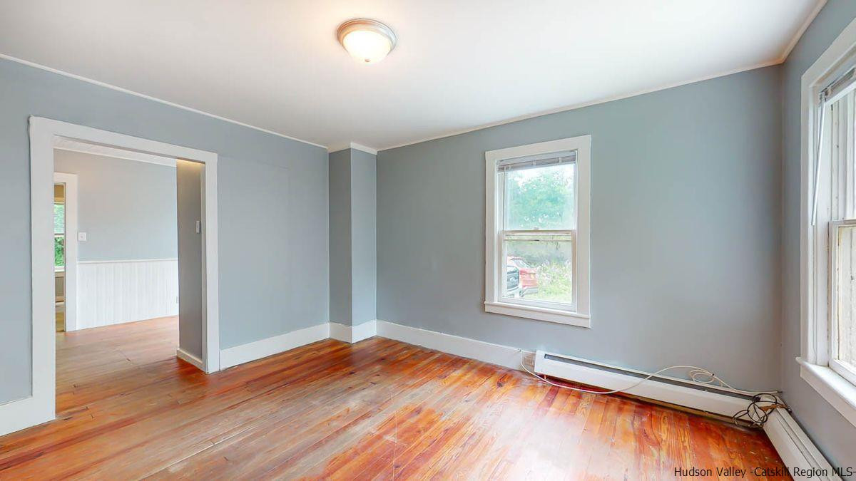 3418 Cooper Street Stone Ridge, NY 12484 - Photo 11 of 34 an empty room with wooden floor and windows