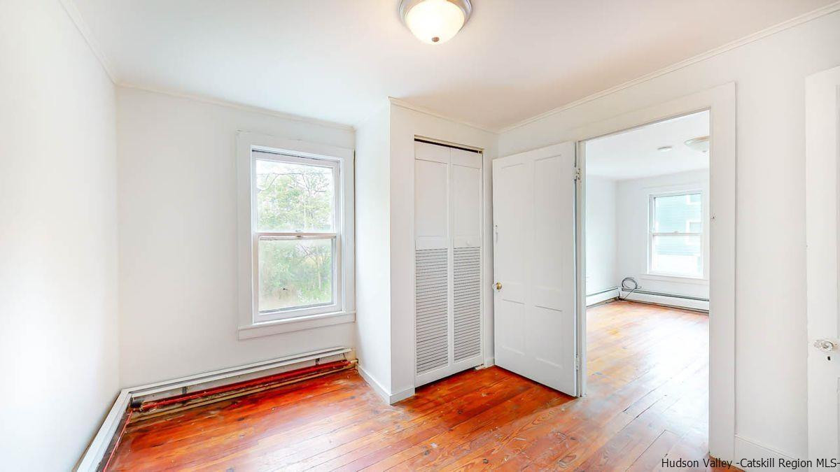 3418 Cooper Street Stone Ridge, NY 12484 - Photo 13 of 34 an empty room with wooden floor and windows