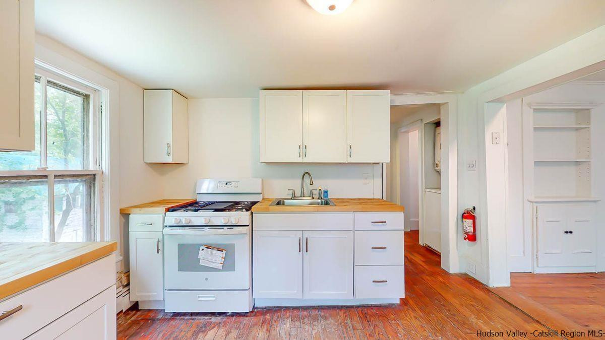3418 Cooper Street Stone Ridge, NY 12484 - Photo 17 of 34 a kitchen with a stove a sink and a refrigerator