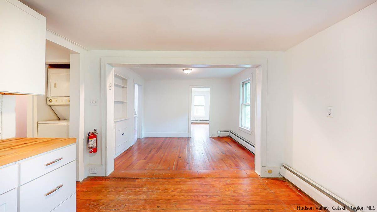 3418 Cooper Street Stone Ridge, NY 12484 - Photo 18 of 34 a hallway with wooden floor and cabinets