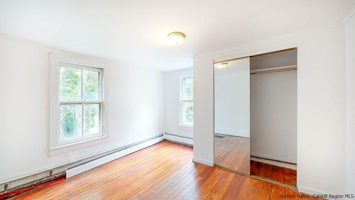 3418 Cooper Street Stone Ridge, NY 12484 - Photo 20 of 34 an empty room with wooden floor and windows