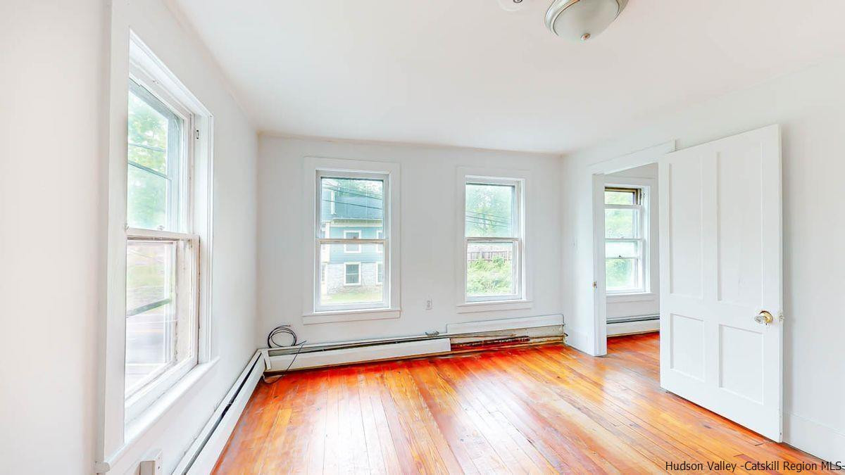 3418 Cooper Street Stone Ridge, NY 12484 - Photo 22 of 34 a view of an empty room with window and wooden floor
