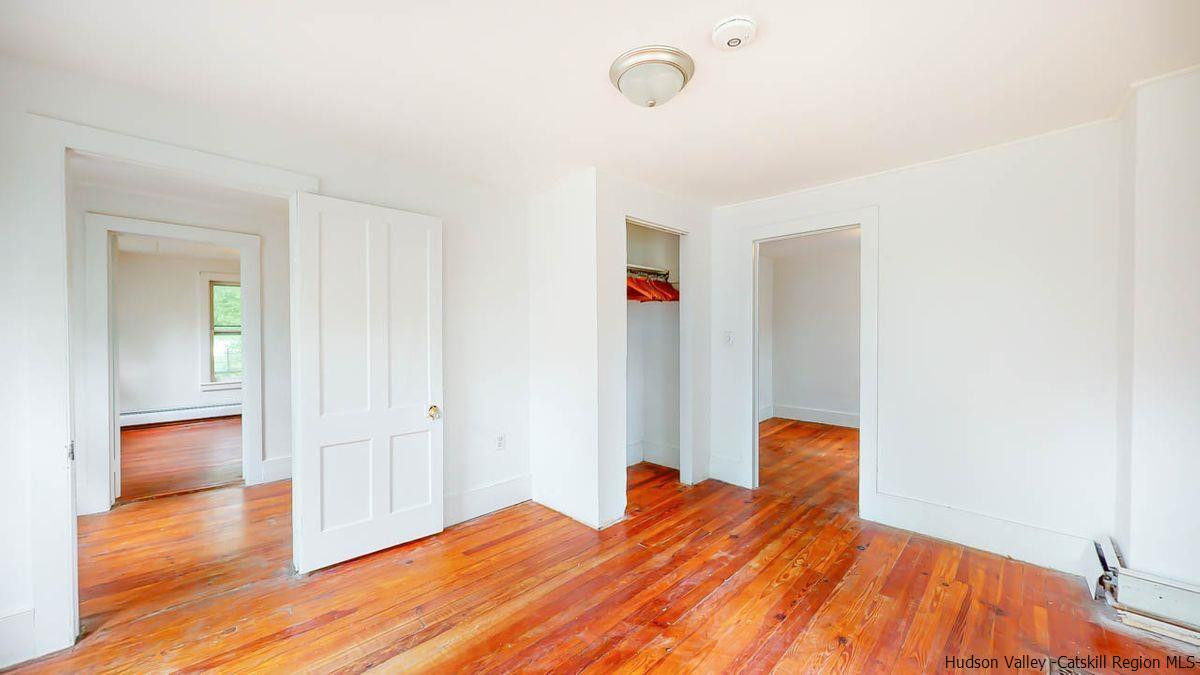 3418 Cooper Street Stone Ridge, NY 12484 - Photo 24 of 34 a bedroom with a bed and wooden floor